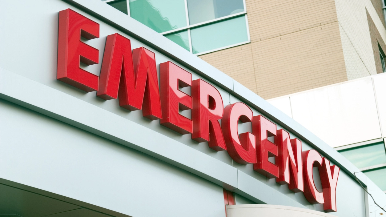 Emergency Room Entrance Exterior view of a hospital emergency room entrance with illuminated signage, indicating access to urgent medical care