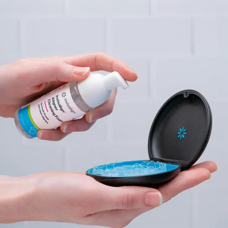 Person cleaning Invisalign clear aligners with a Invisalign cleaner
