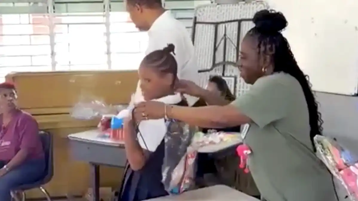 Violet gives out dental supplies to community members during a Midtown Dental Group mission trip